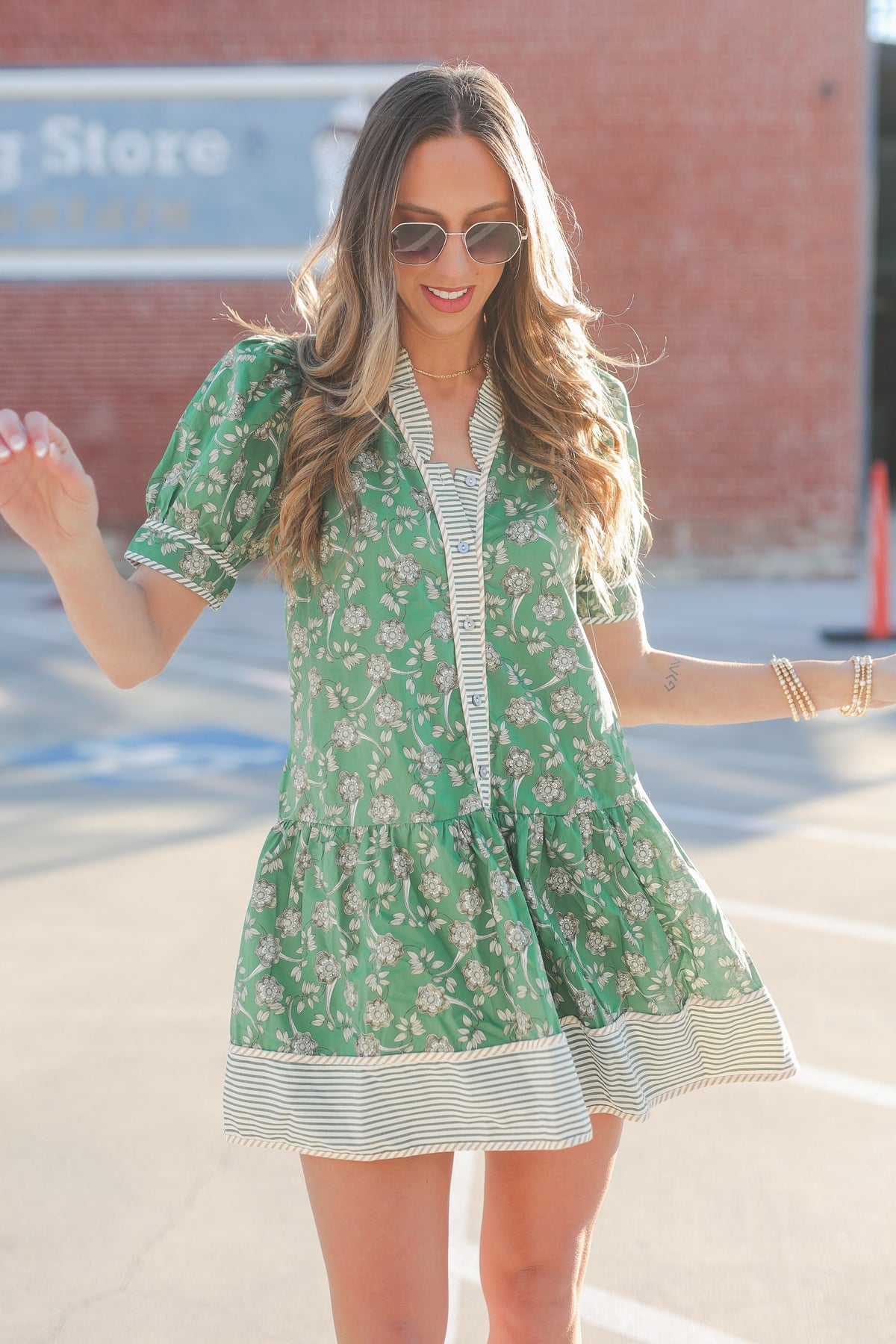 Woman wearing a green floral dress with a blurred background
