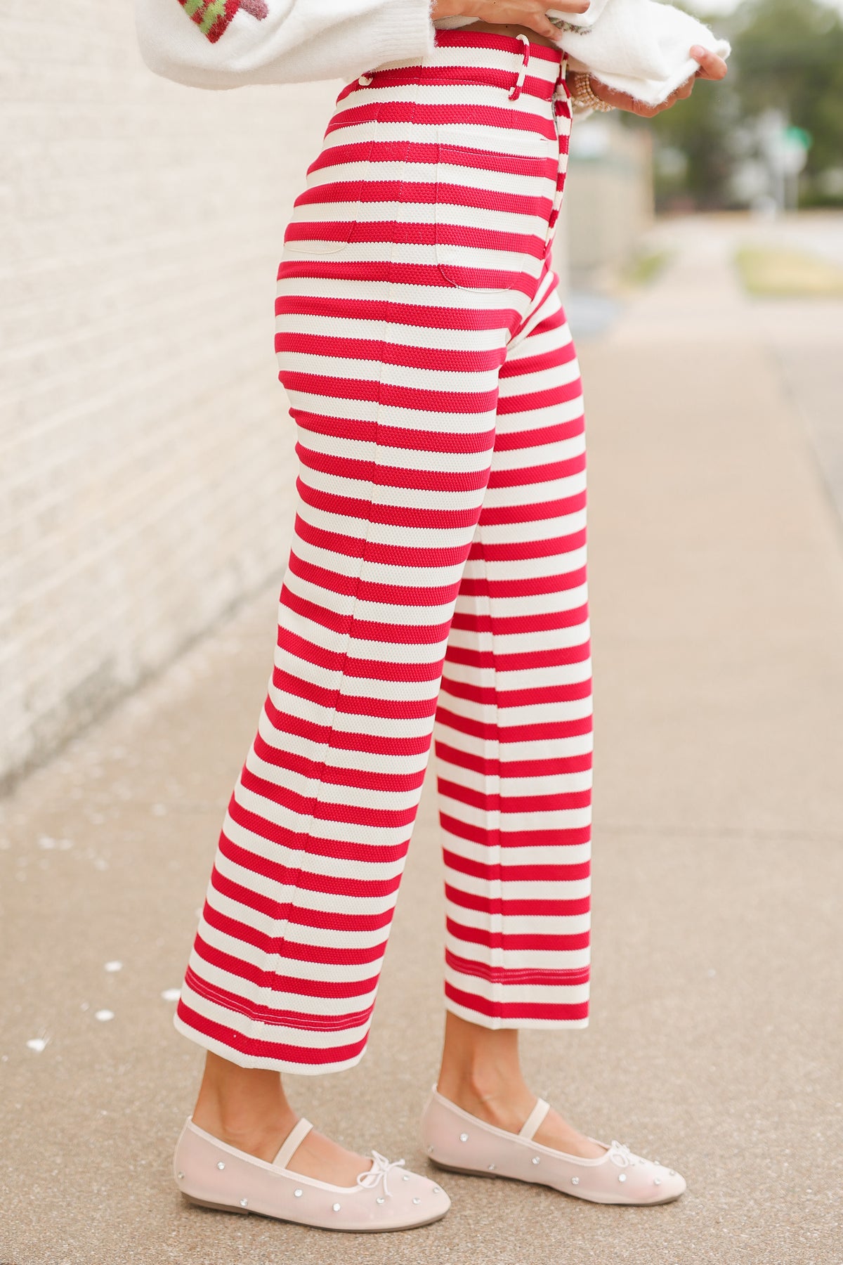 Close up of the Candy Cane Lane Stripe Knit Pants in red and cream featuring bold horizontal stripes, high-rise waistband, front button closure, belt loops, and straight-leg fit. Southern House Clothing