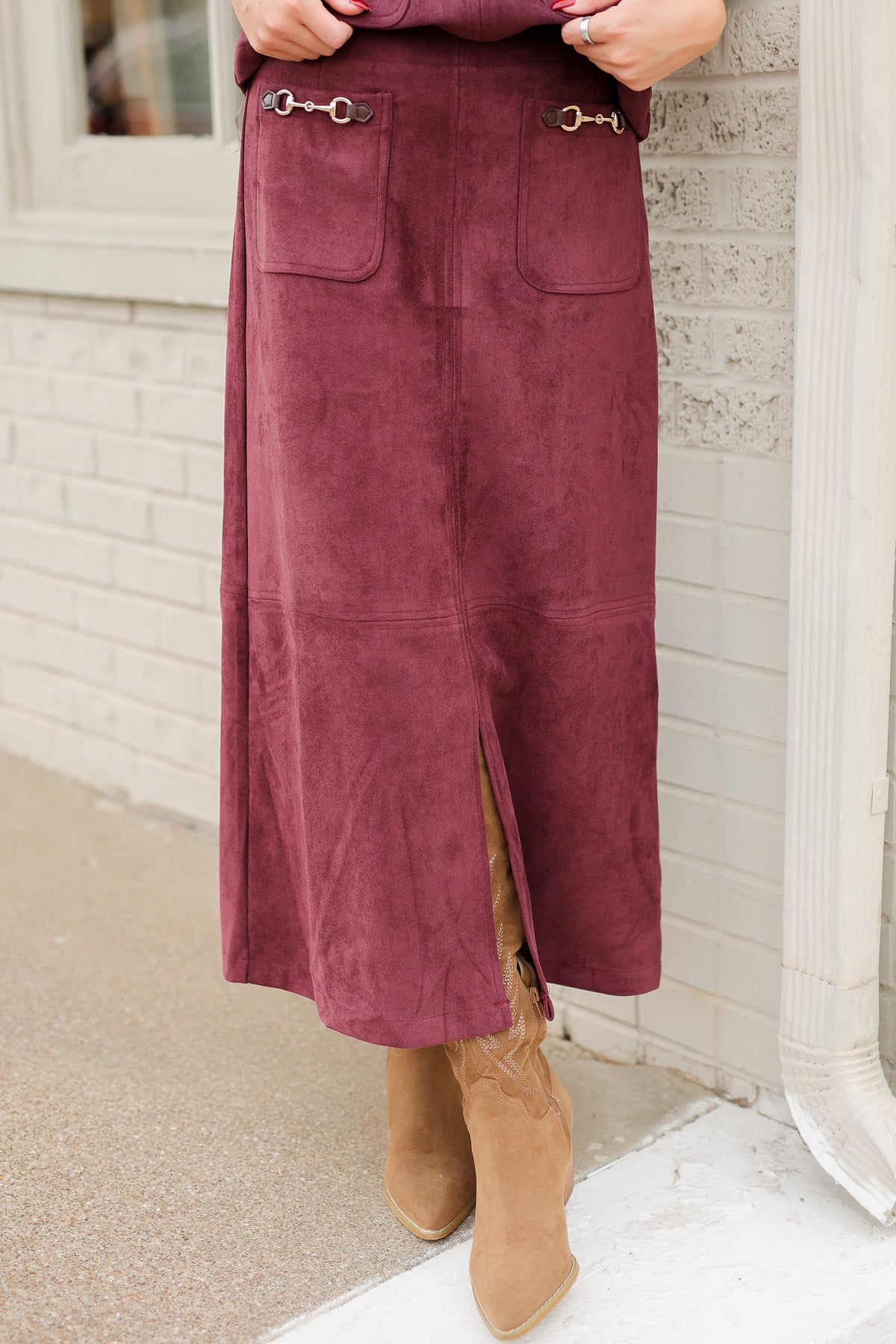 Close up of a matching burgundy colored maxi length skirt worn by a model. Southern House Clothing.