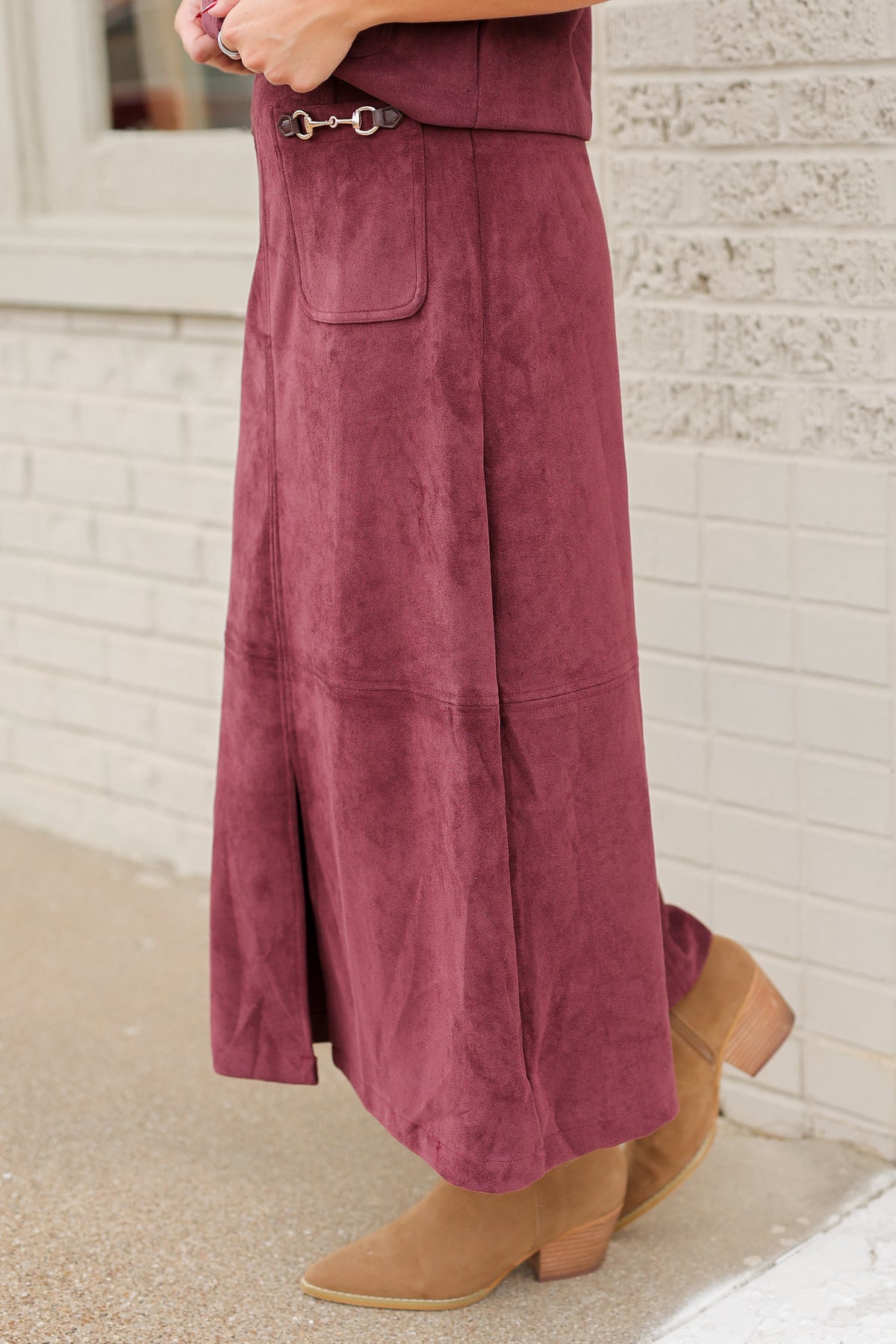 Close up of a matching burgundy colored maxi length skirt worn by a model. Southern House Clothing.