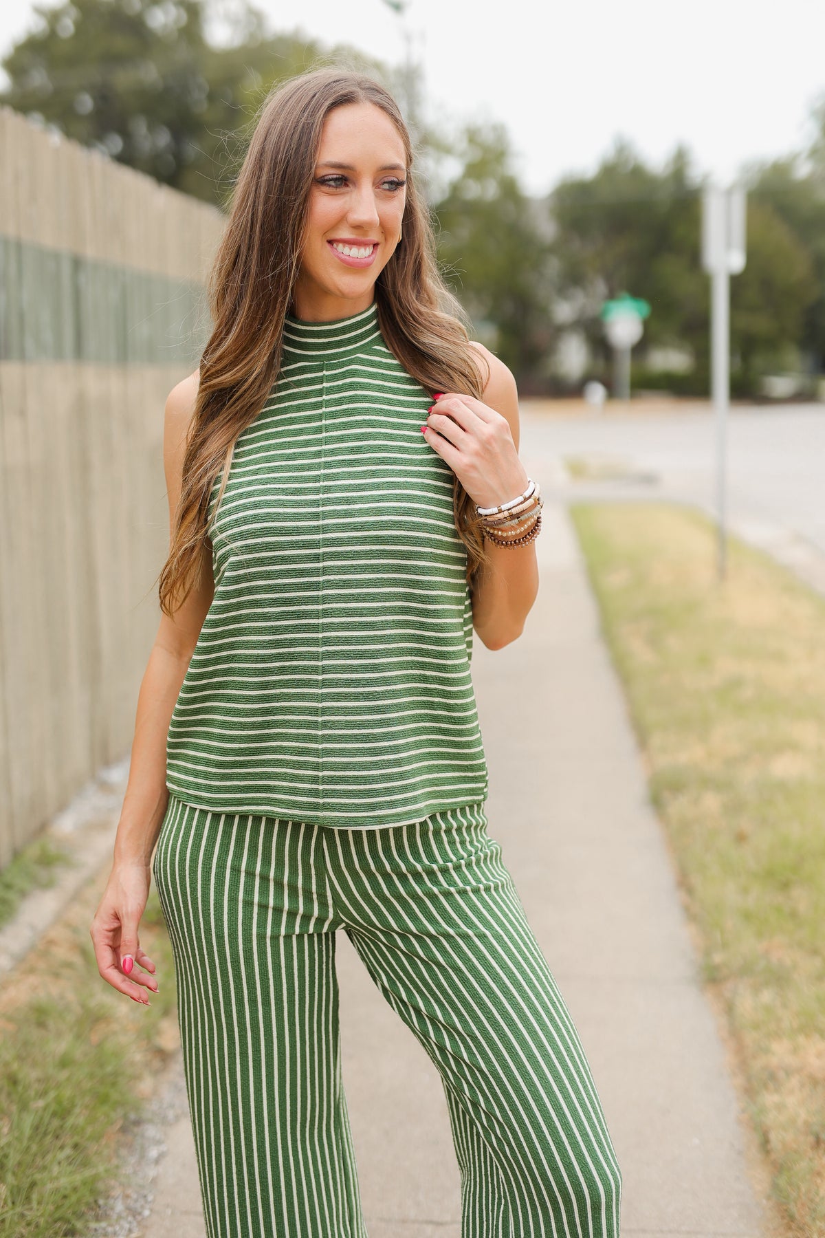 Blonde model wearing a green striped set outdoors. Southern House Clothing