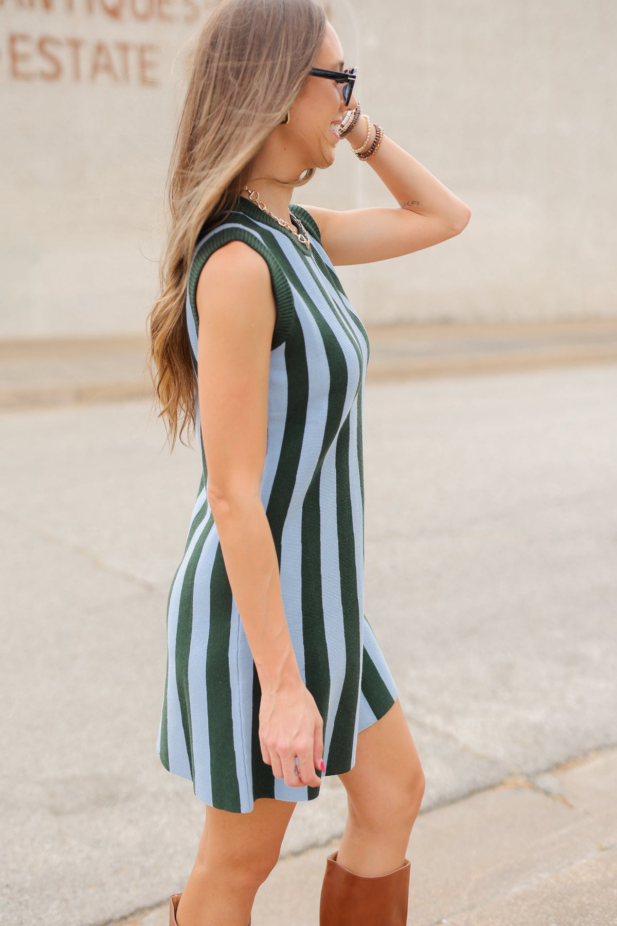 Blonde model wearing a sea green dress from Southern House Clothing outside