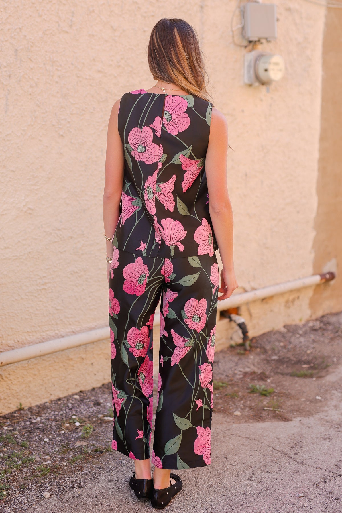 woman wearing a floral set outside.