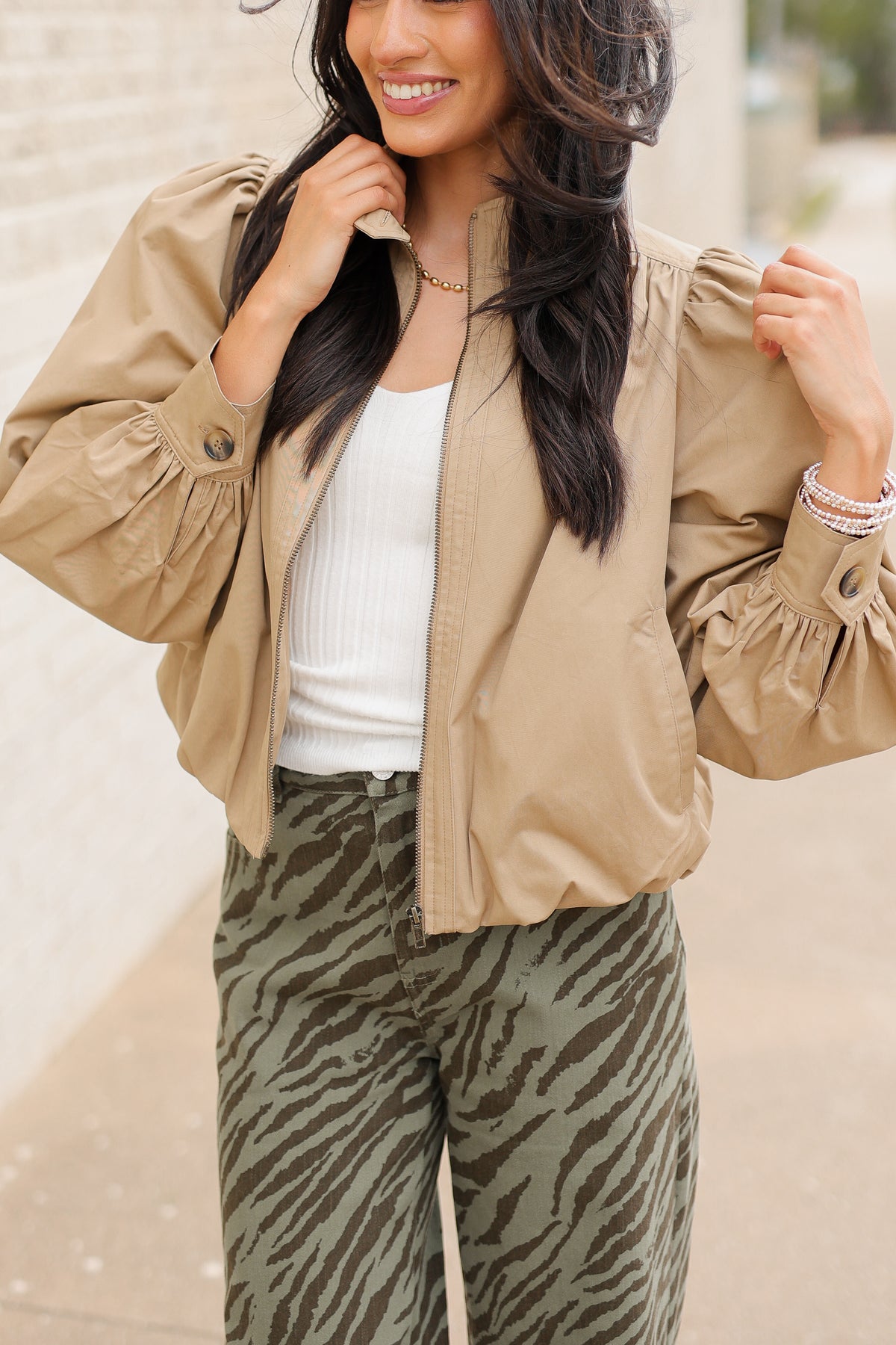 Winscott Puff Sleeve Zip Jacket in Khaki styled with Safari Stroll Wide Leg Pants in olive animal print and metallic gold ballet flats, showing the cropped fit and puff sleeves. Southern House Clothing