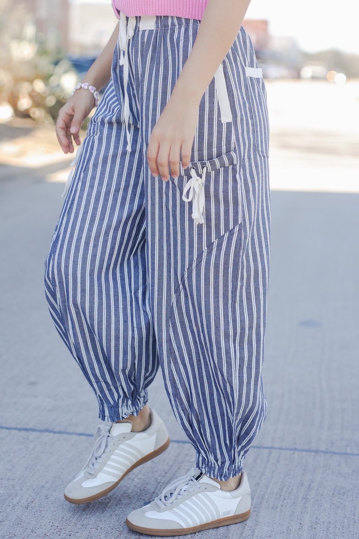 Person wearing blue and white striped pants with a blurred background