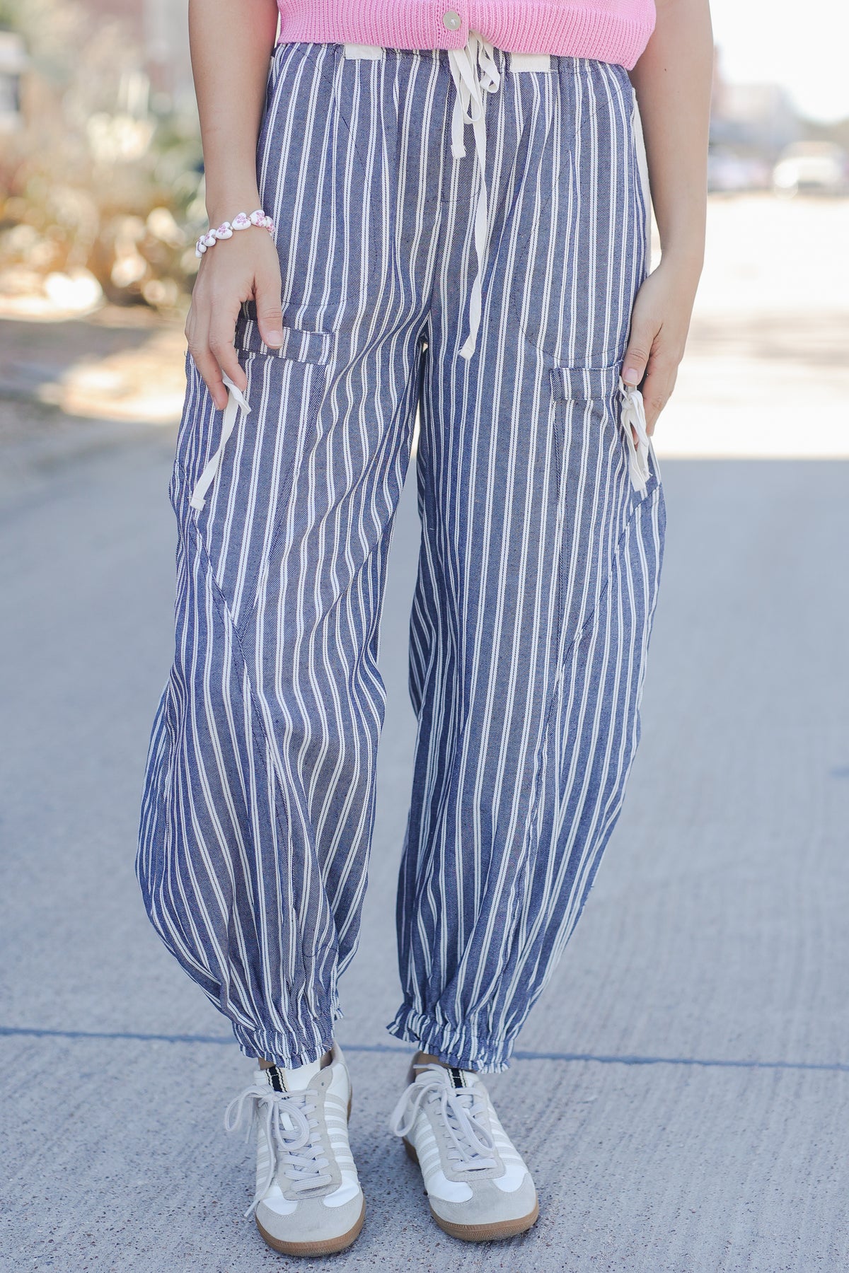 Person wearing blue and white striped pants with a blurred background