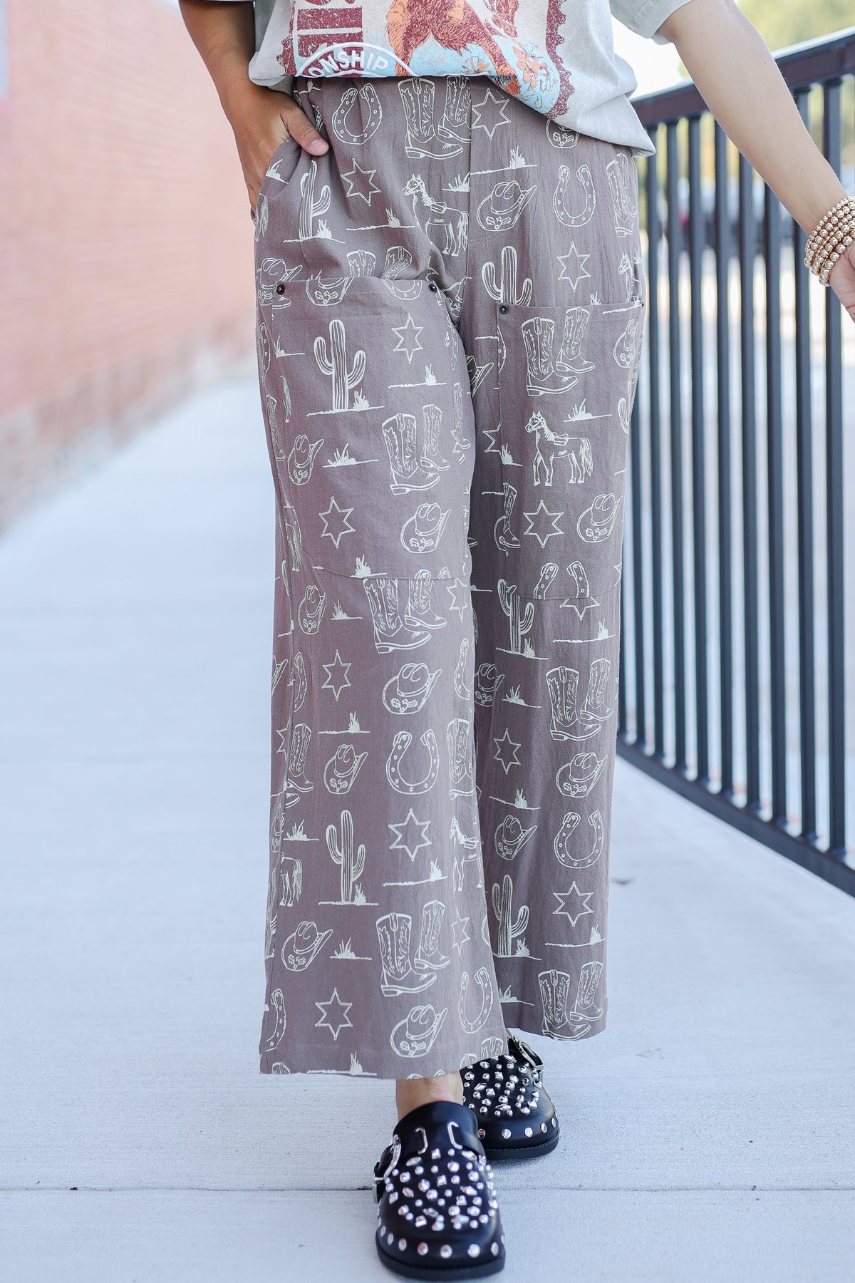 Person wearing patterned pants with a neutral background