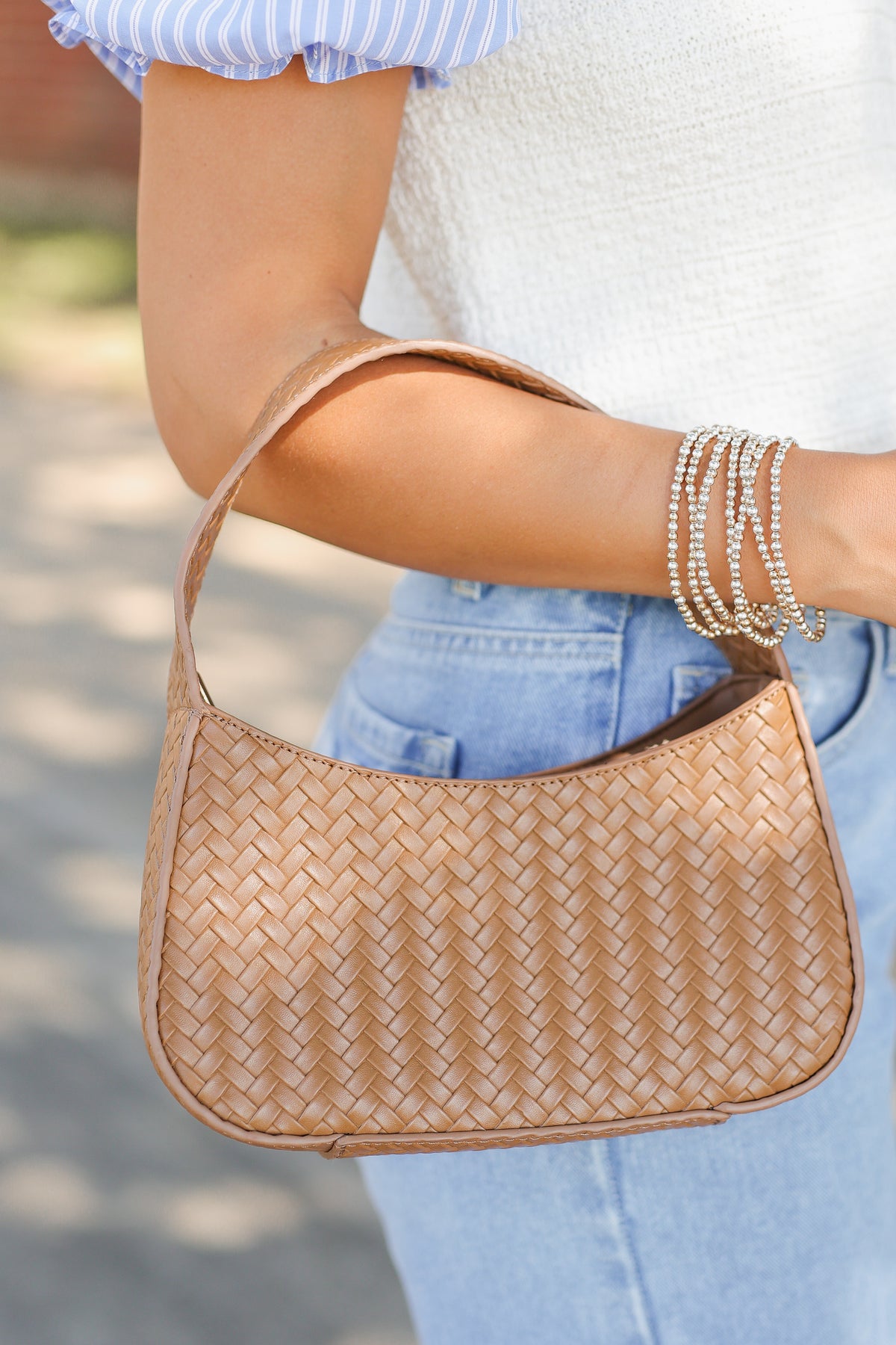 woman holding a brown purse