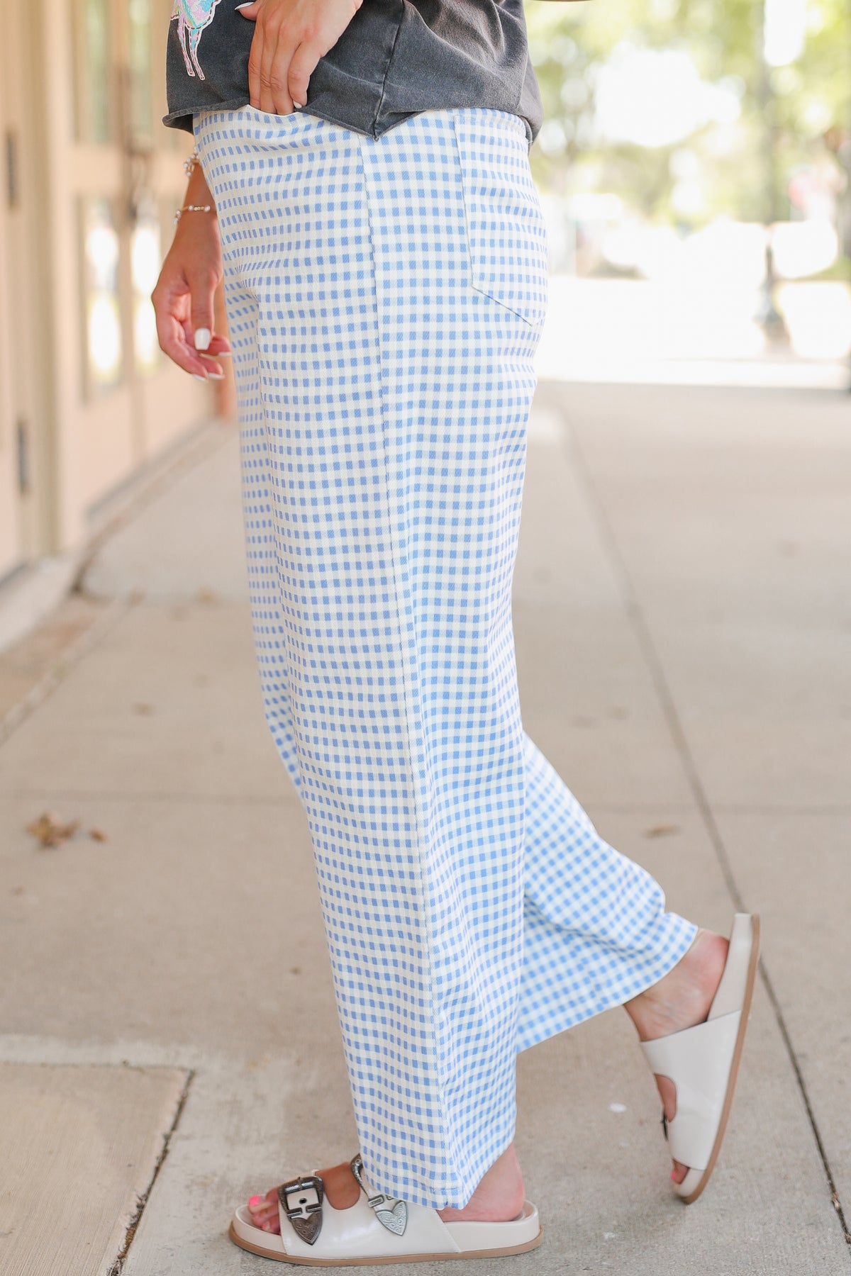 Close up of blue gingham pants on a model.