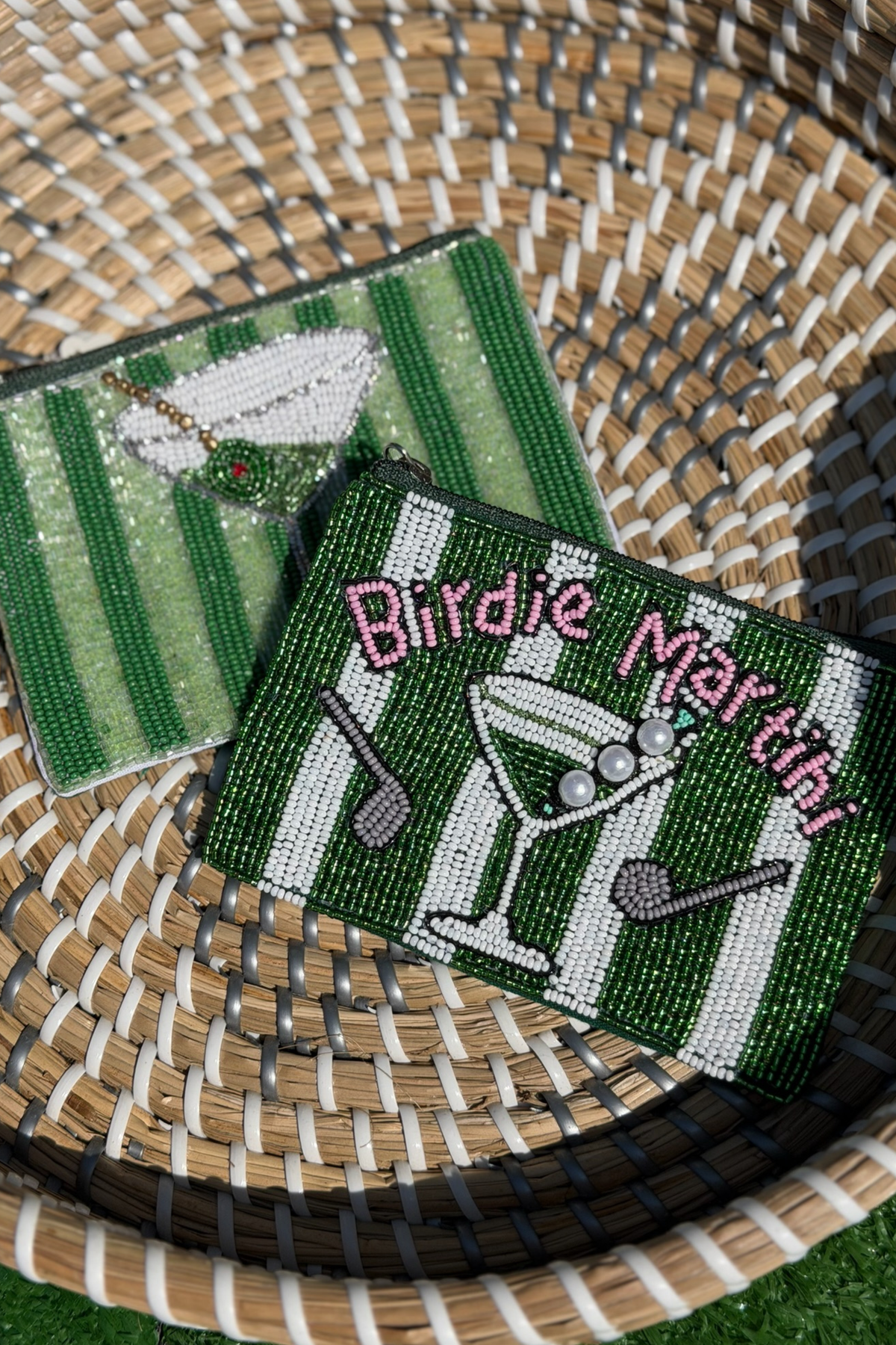 Two beaded coasters with golf-themed designs on a woven surface