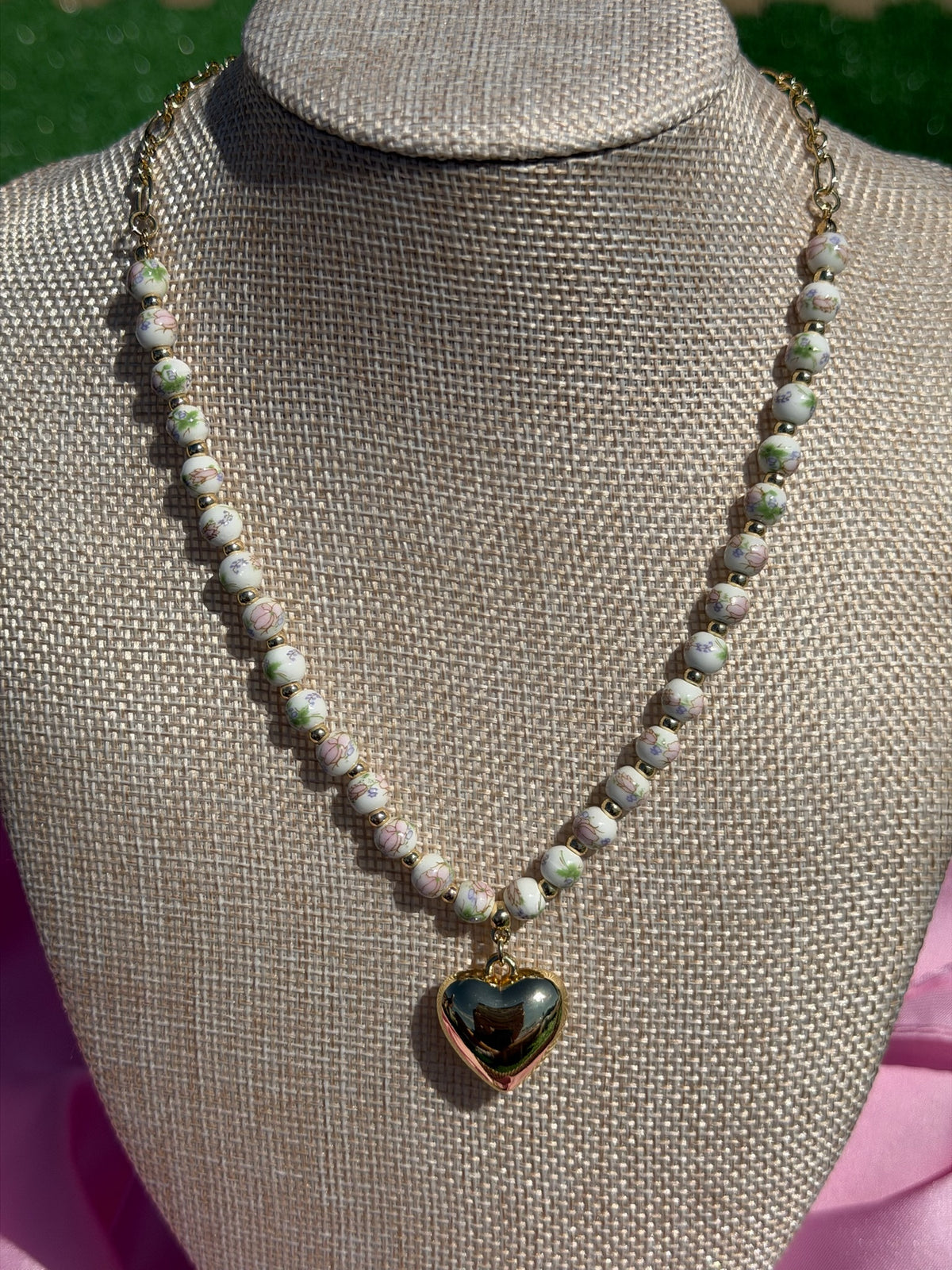 Necklace with a heart-shaped pendant on a mannequin bust.