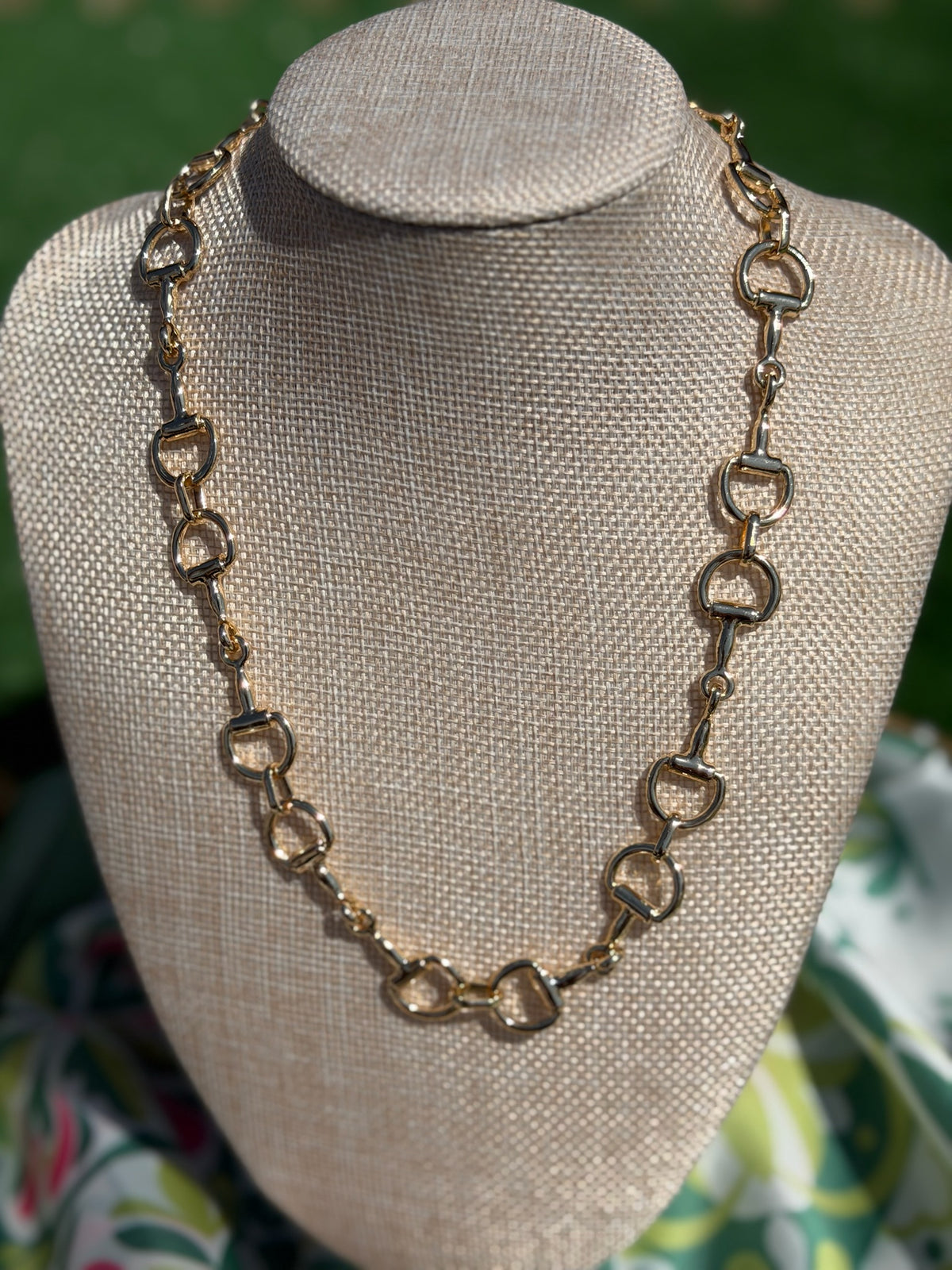 Necklace on a mannequin bust with a blurred background