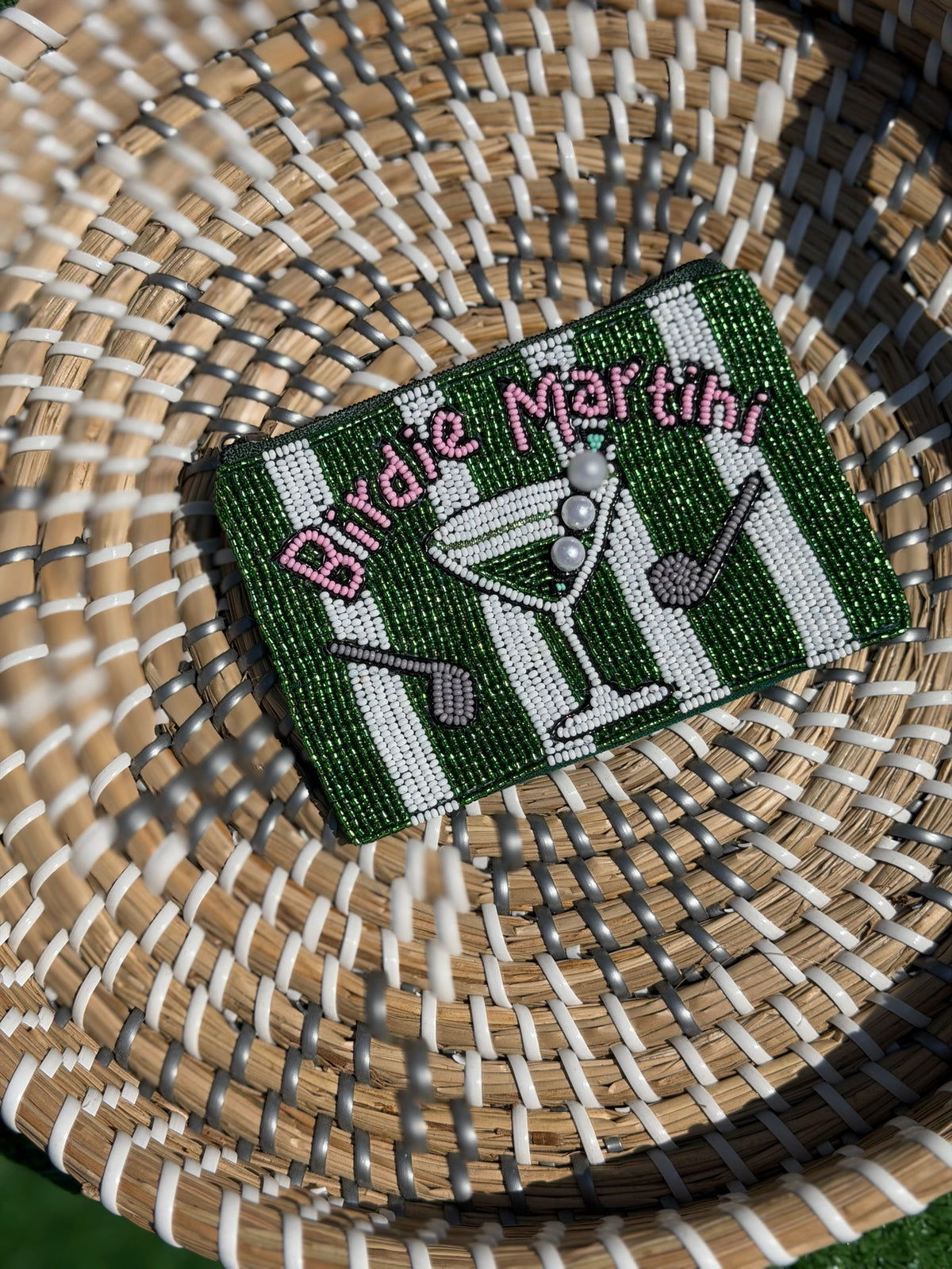 Embroidered patch with 'Birdie Martini' design on a woven surface