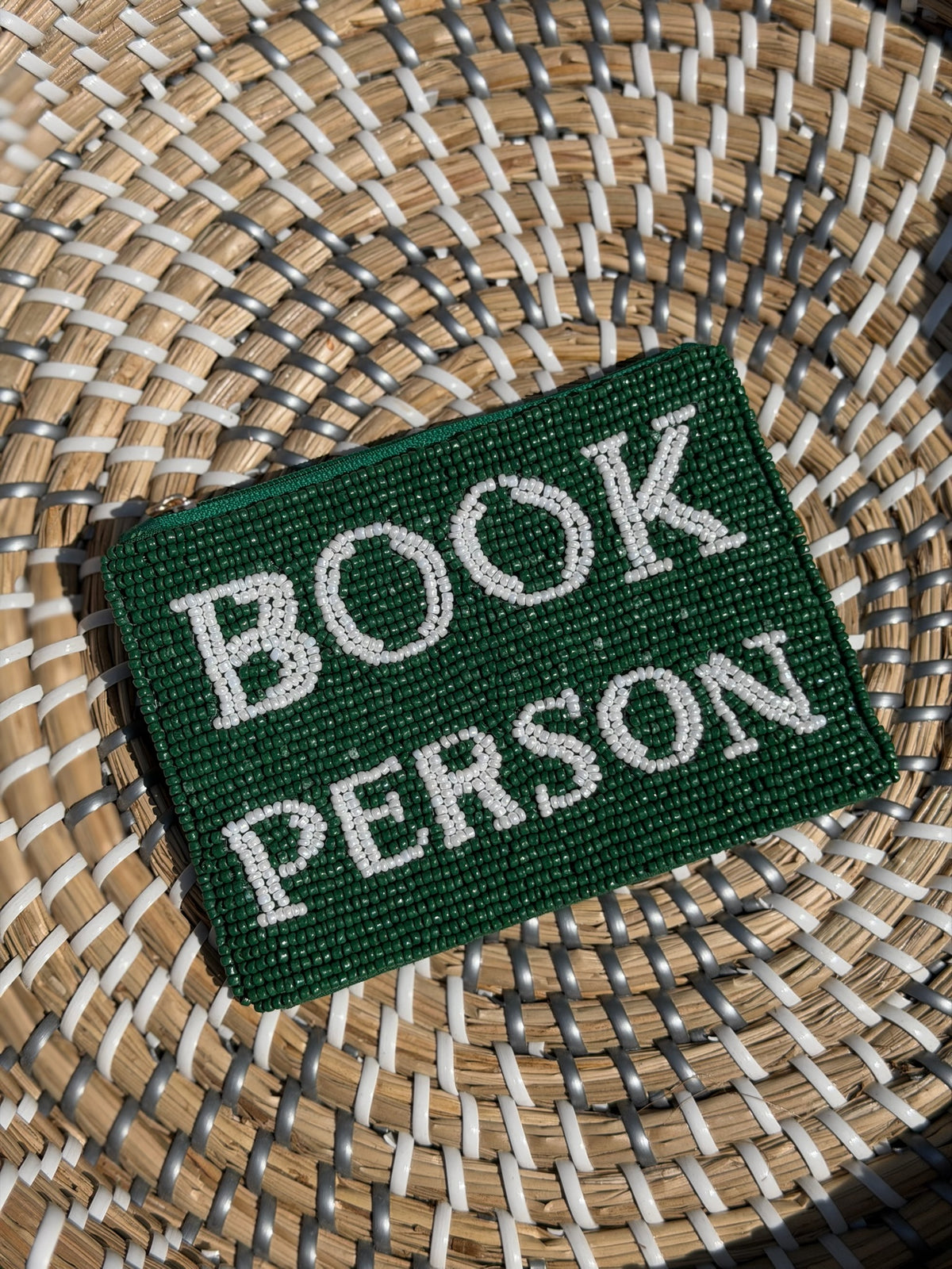 Green patch with 'BOOK PERSON' text on a woven surface