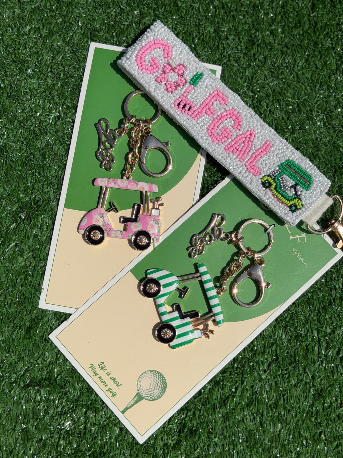 Keychain with golf-themed design on a green surface