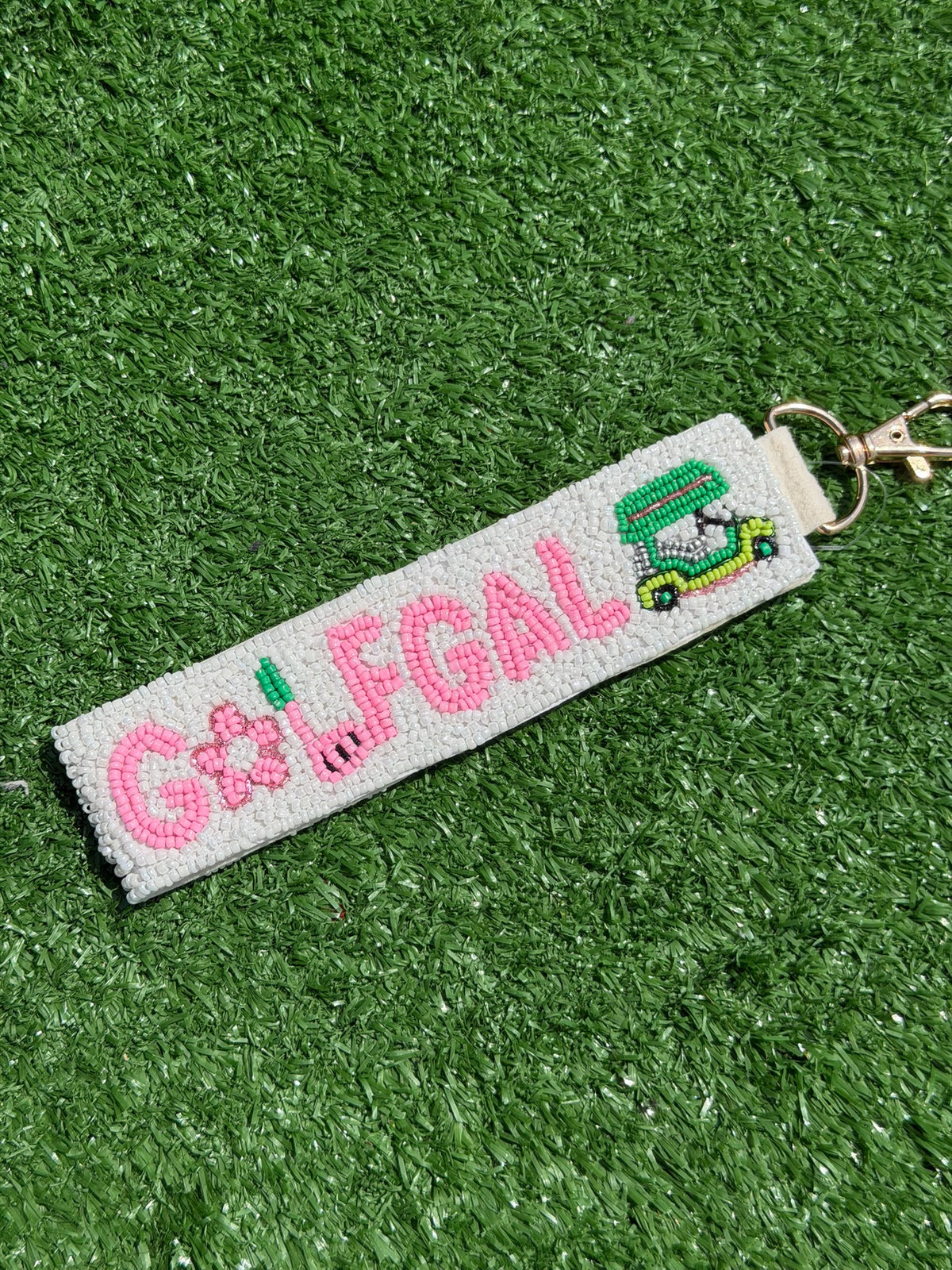 Keychain with 'GALFGAL' text and golf-themed design on a grass background