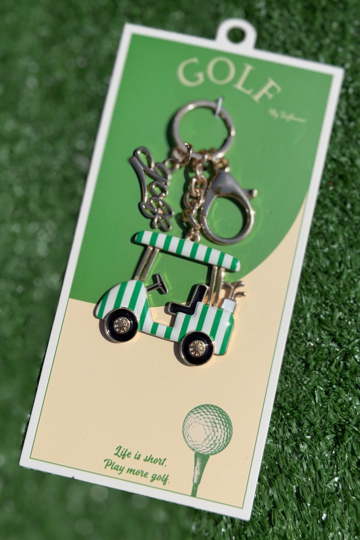Golf-themed keychain with cart and golf club on a green and beige card with 'GOLF' text.