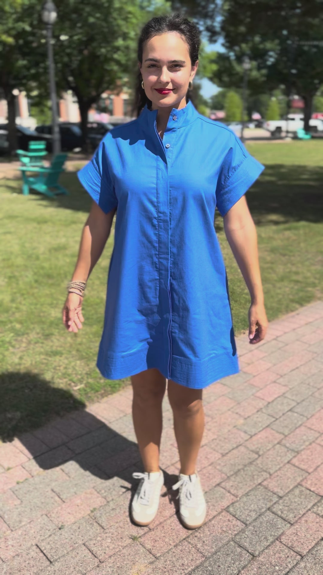 Woman in a blue dress walking on a sidewalk