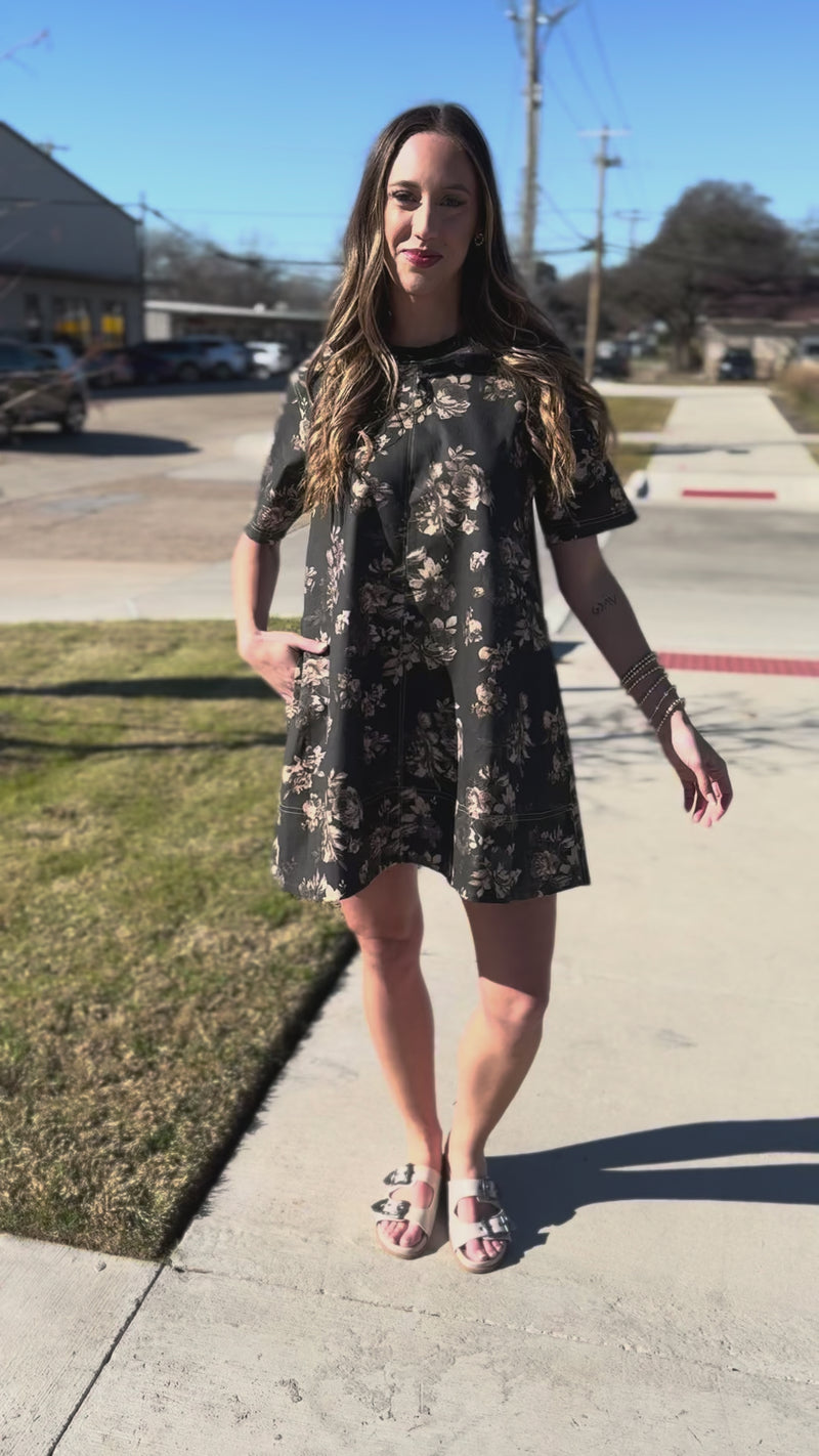 Woman wearing a floral dress standing outside