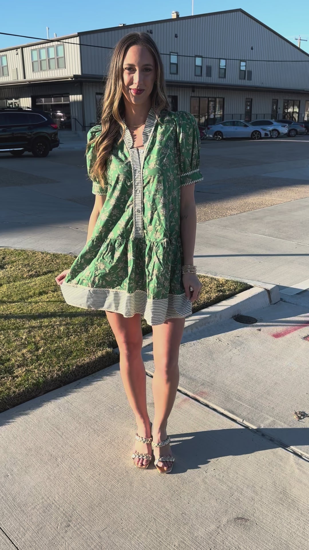 Woman wearing a green floral dress with a blurred background