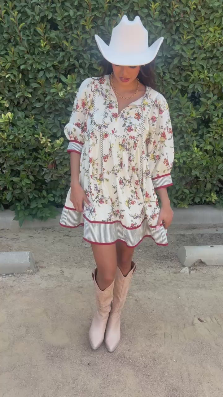 Brunette model wearing an ecru dress and cowboy hat in an outdoor setting. Southern House Clothing