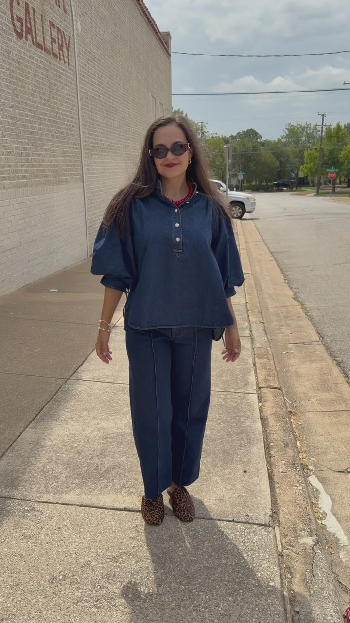 Model wearing the Westhaven Puff Sleeve Denim Top in Dark Wash with Langley Pants and Atlas Leopard Hair Shoes, styled with a red statement necklace. Southern House Clothing