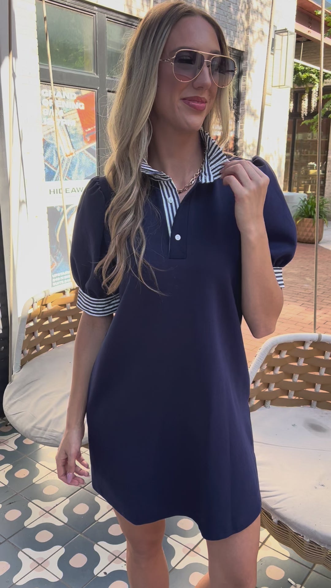 Harbor Stripe Polo Dress in Nay worn by a blond model in glasses, outside. Southern House Clothing