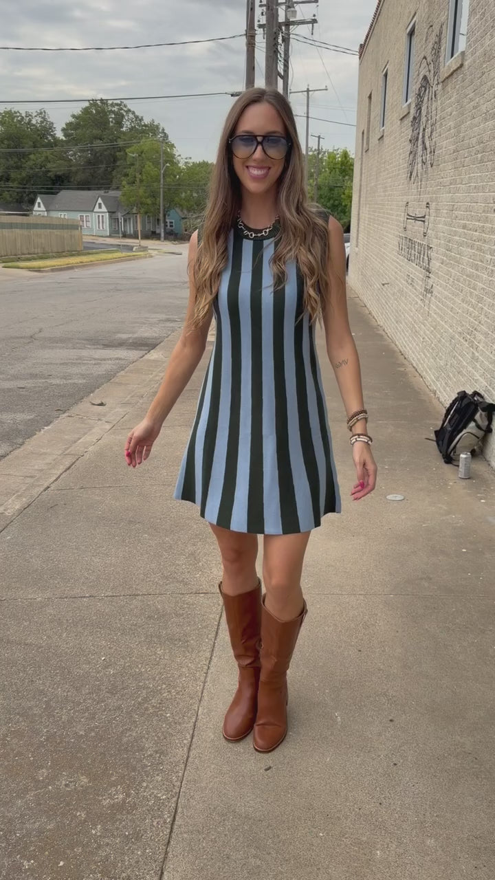 Blonde model wearing a sea green dress from Southern House Clothing outside