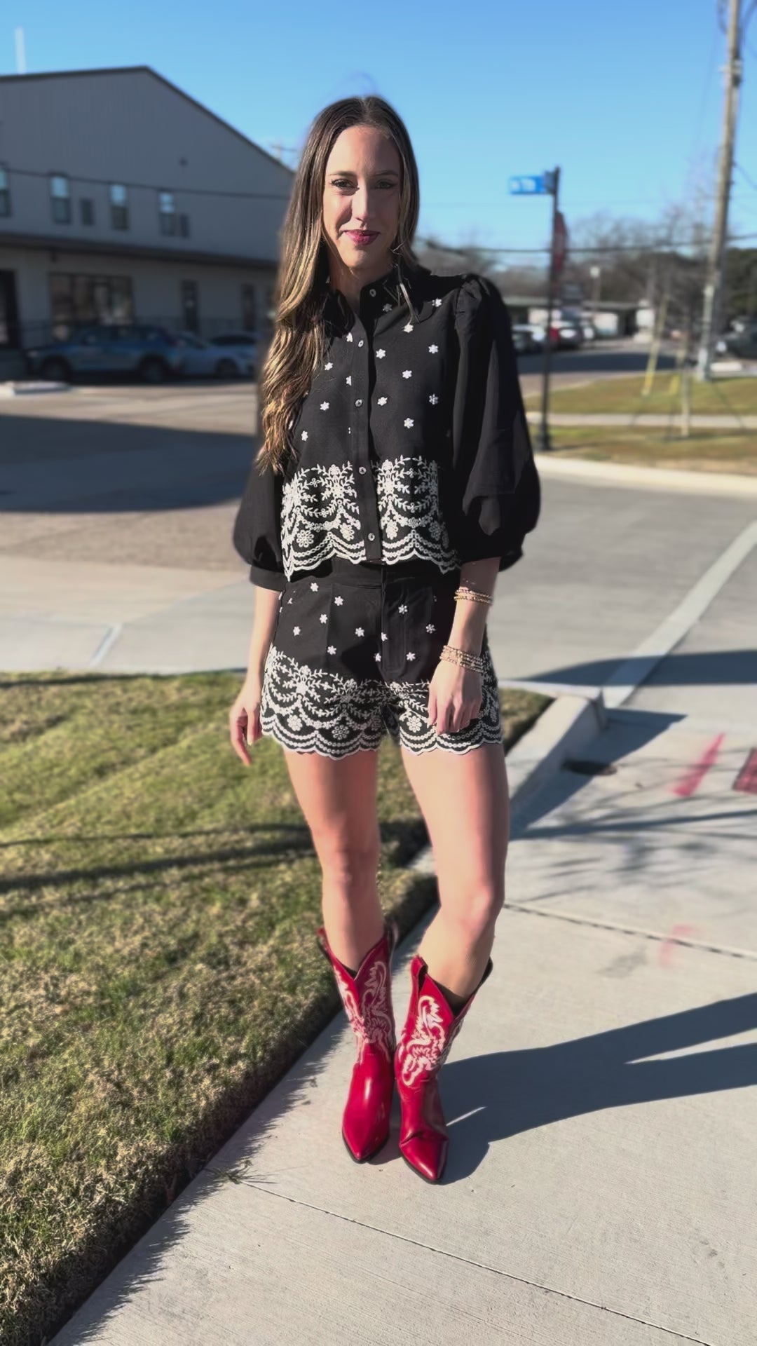 Woman wearing a black and white patterned outfit with lace details.