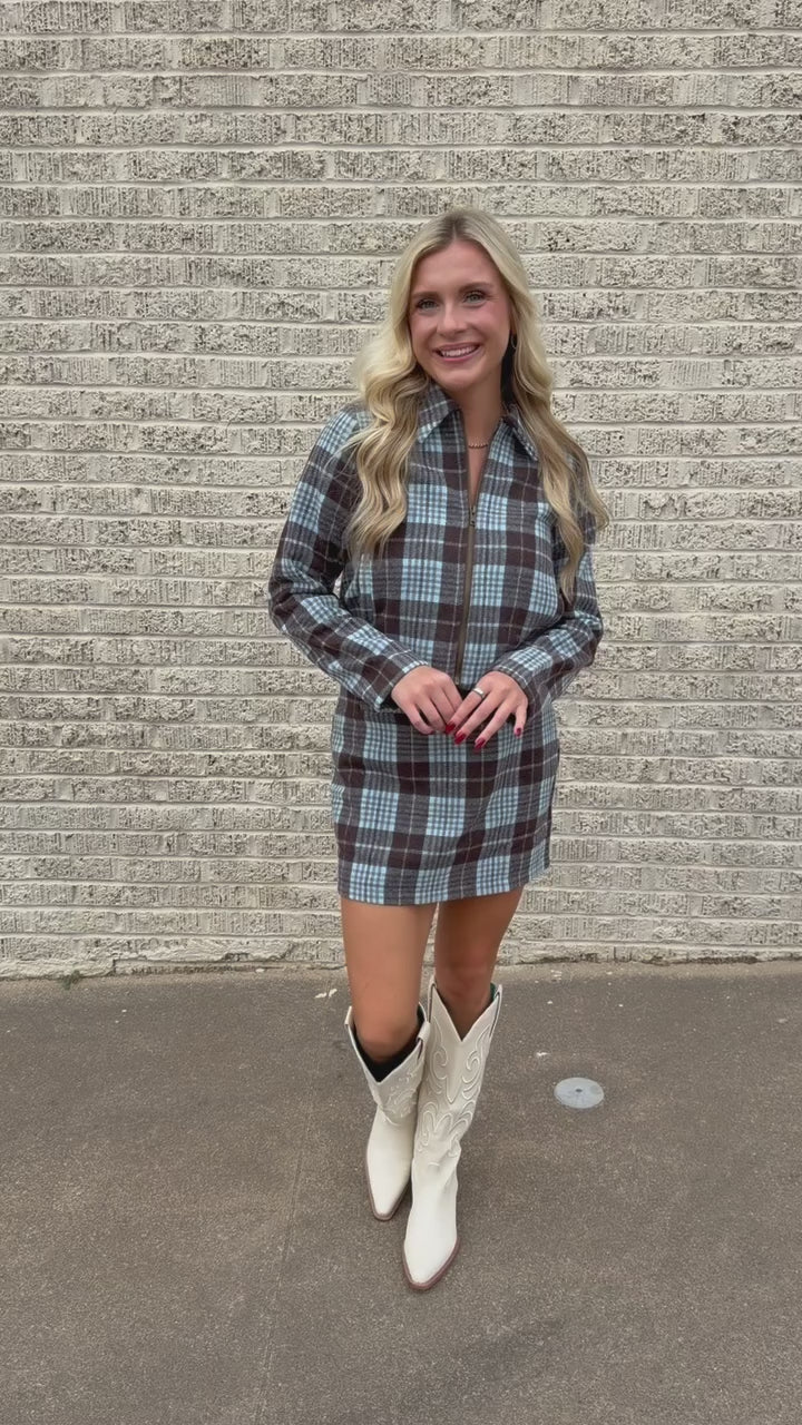 Blonde model standing outside wearing a blue and brown jacket and skirt set. Southern House Clothing