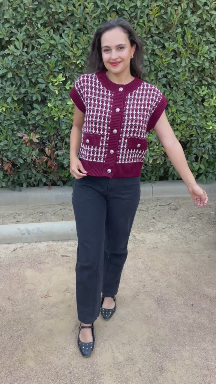 Brunette model wearing a red sweater and jeans in an outdoor setting. Southern House Clothing. 
