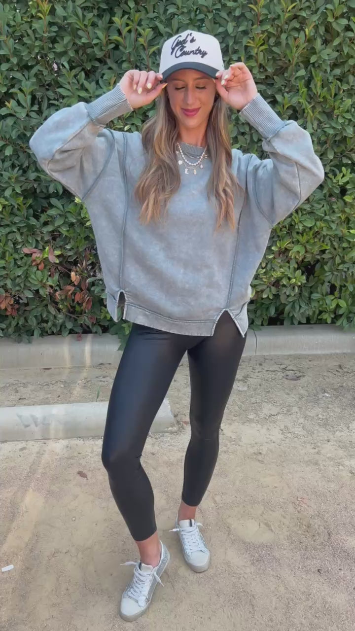 Brunette model in an ash jade sweater and leggings in an outdoor setting. Southern House Clothing