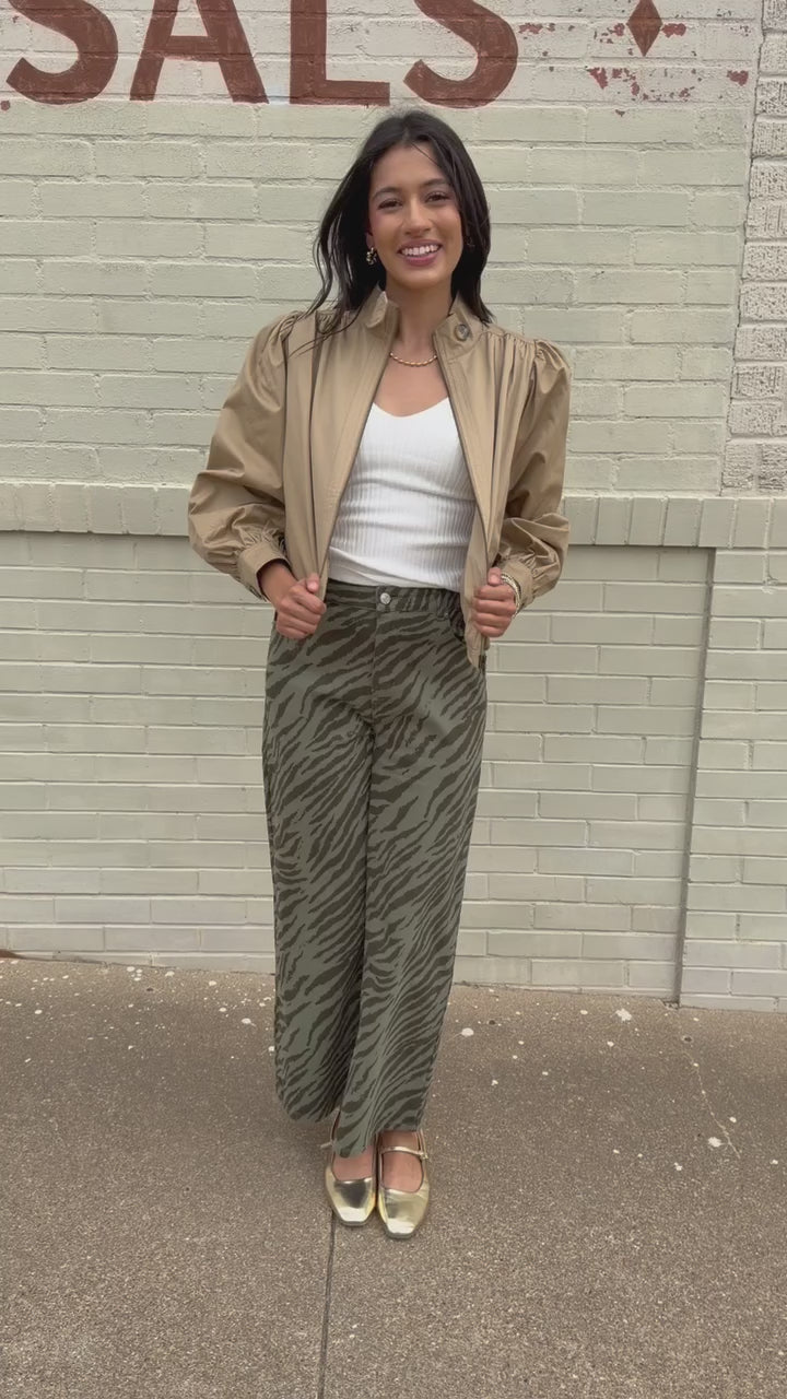Winscott Puff Sleeve Zip Jacket in Khaki styled with Safari Stroll Wide Leg Pants in olive animal print and metallic gold ballet flats, showing the cropped fit and puff sleeves. Southern House Clothing