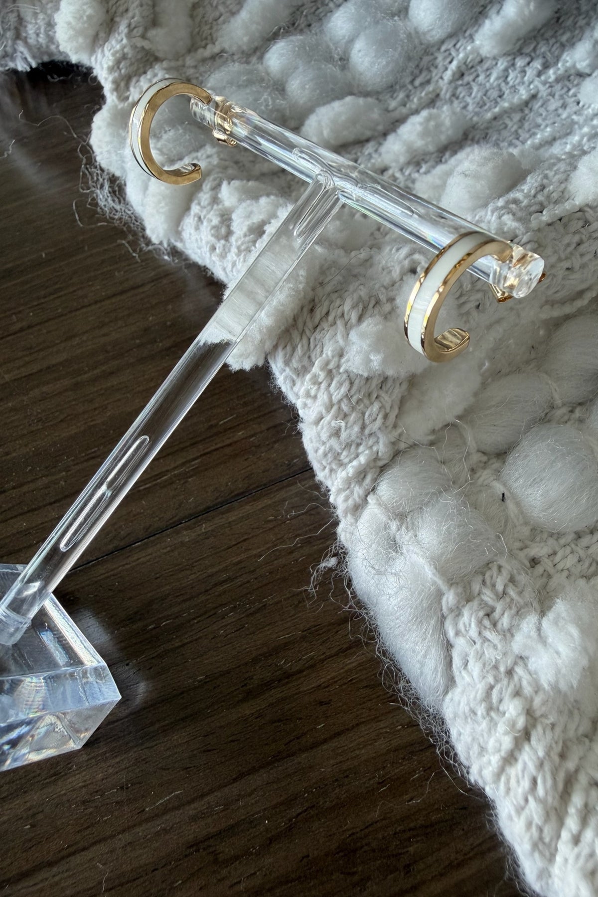 Clear crystal key with gold accents on a textured white surface